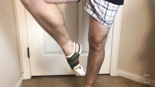 Man does Calf Flexing with X-Mas Socks